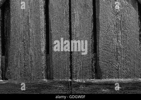 Wood and tar texture on some plank. Black wooden wall in bright sunshine. Recently tarred. BW, HDR-toning. Stock Photo