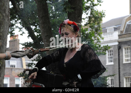 London, UK. 16th July, 2016. A competitor is about to get throttled, during the Bicycle Joust, at the 2016 Chap Olympiad, in London's Bedford Square. Credit:  Dario Earl/Alamy Live News Stock Photo