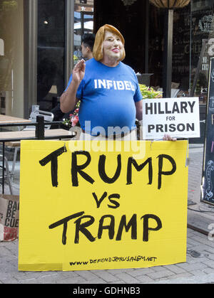 Cleveland, Ohio, USA. 16th July, 2016. Bob Kunst, 74 of Miami Beach, Florida, an international pioneer of Gay Rights and President of Shalom International, campaigns wears a mask to mock former United States Secretary of State Hillary Clinton near the Quicken Loans Arena, site of the 2016 Republican National Convention in Cleveland, Ohio on Saturday, July 16, 2016. Kunst is a former supporter of Hillary Clinton and from 2003 to 2008 was president of hillarynow.com, an effort to draft Secretary Clinton to run for President of the United States.Credit: Ron Sachs/CNP. (Cr Stock Photo