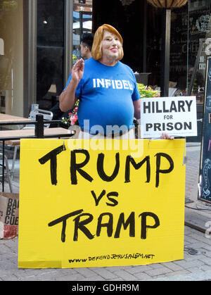 Bob Kunst, 74 of Miami Beach, Florida, an international pioneer of Gay Rights and President of Shalom International, campaigns wears a mask to mock former United States Secretary of State Hillary Clinton near the Quicken Loans Arena, site of the 2016 Republican National Convention in Cleveland, Ohio on Saturday, July 16, 2016. Kunst is a former supporter of Hillary Clinton and from 2003 to 2008 was president of hillarynow.com, an effort to draft Secretary Clinton to run for President of the United States. Credit: Ron Sachs/CNP (RESTRICTION: NO New York or New Jersey Newspapers or newspapers Stock Photo