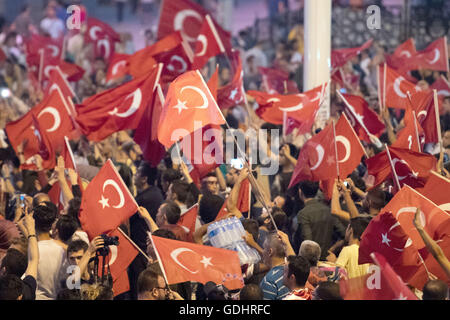 Istanbul, Turkey. 17th July, 2016. People shout slogans and hold flags during a demonstration at Taksim Square in Istanbul, Turkey, 17 July 2016. Turkish authorities state they have regained control of the country after thwarting a coup attempt. Photo: Marius Becker/dpa/Alamy Live News Stock Photo