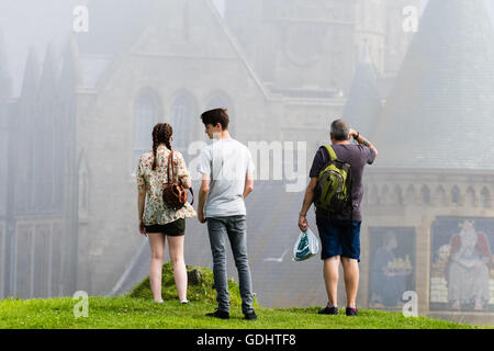 Aberystwyth Wales UK, Sunday 18 July 2016 UK weather: People looking at the gothic towers of the university Old College in Aberystwyth on a misty July summer morning . The weather is forecast to improve dramatically today and on Tuesday, with temperatures forecast to soar to over 30º centigrade in parts of the south east Credit:  Keith Morris/Alamy Live News Stock Photo
