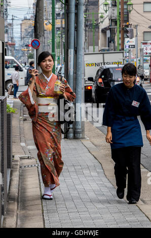 Ladies wearing traditional Japanese Kimono on streets of Kyoto Japan Stock Photo