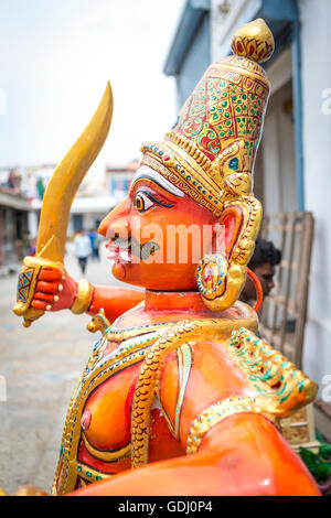 An orange statuette of Ravana being repaired at the Kapaleeshwarar Temple, Mylapore, Chennai, Tamil Nadu, India Stock Photo