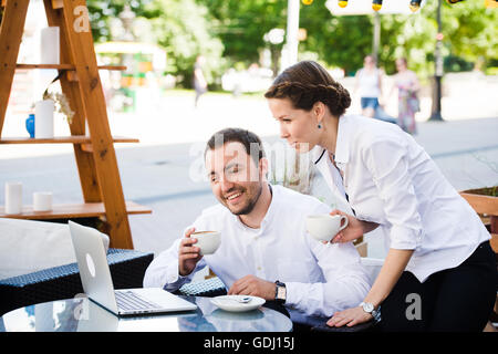 Business colleagues working on their break at the coffee shop Stock Photo