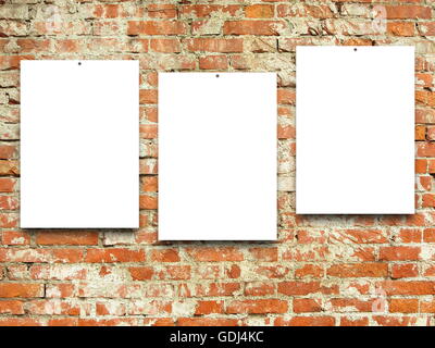 Close-up of three nailed blank frames on orange weathered brick wall background Stock Photo