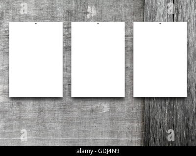 Close-up of three nailed blank frames on gray weathered wooden boards background Stock Photo