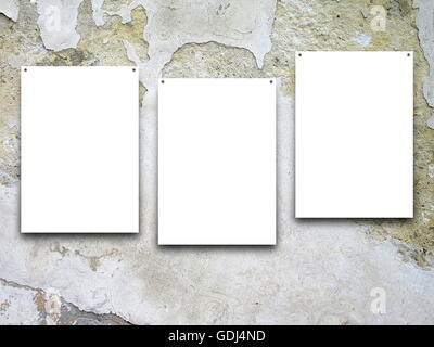Close-up of three nailed blank frames on gray scratched concrete wall background Stock Photo