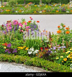 Alley in the park with beautiful flower beds Stock Photo