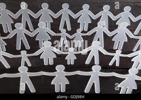Human chain on black background Stock Photo