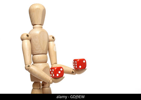Wooden puppet holds dice on white background with clipping path Stock Photo