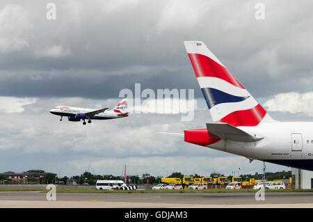 British Airways aircraft landing and taxiing at London Heathrow Airport Stock Photo