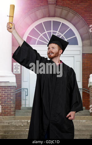 Young man in his graduation robes Stock Photo