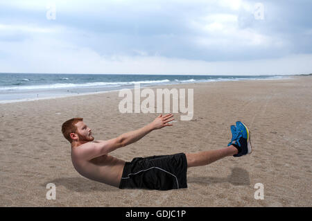 Young man doing exercises by doing crunches Stock Photo