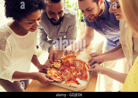 happy business team eating pizza in office Stock Photo