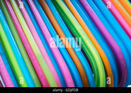 set of colorful coat hanger hanging on rail Stock Photo