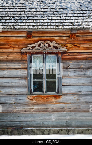 Window frame of a wooden log cabin Stock Photo