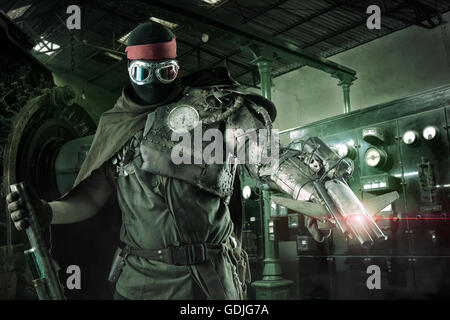 Futuristic soldier posing with gun and armor Stock Photo