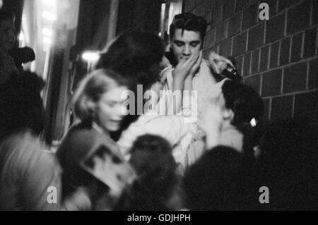 Elvis Presley mobbed by fans after a performance at the University of Dayton Fieldhouse, May 27, 1956.