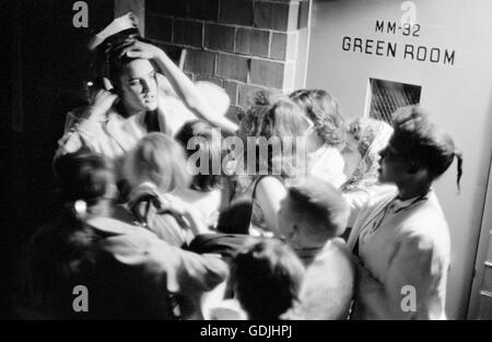 Elvis Presley mobbed by adoring fans backstage after a performance at the University of Dayton Fieldhouse, May 27, 1956.