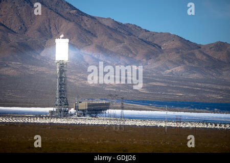 One of the towers of the Ivanpah Solar Electric Generating System  in the Mojave Desert California brightly lit by sunlight Stock Photo