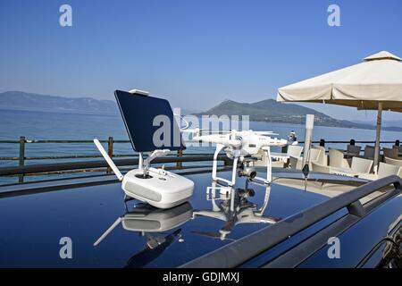 Drone aircraft and the control unit the car roof. Stock Photo