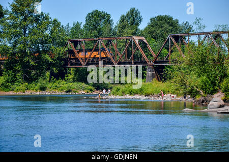 Sandy River scene in Troutdale Oregon, with train on trestle Stock Photo