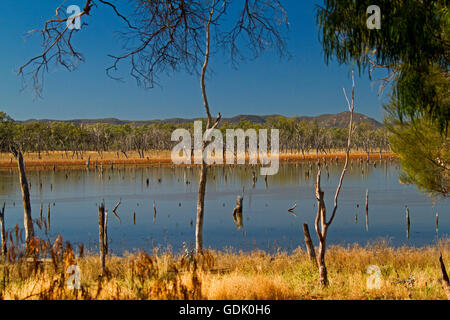 Vast calm blue waters of Lake Nuga Nuga with rugged Carnarvon ranges on horizon under blue sky in outback Qld Australia Stock Photo