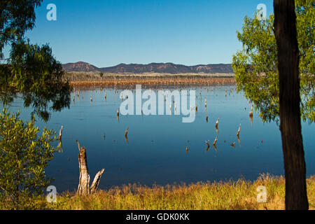 Vast calm blue waters of Lake Nuga Nuga with rugged Carnarvon ranges on horizon under blue sky in outback Qld Australia Stock Photo