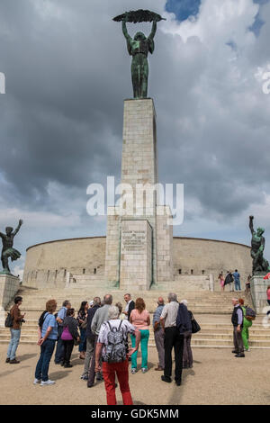 Tourist group at Liberty Statue (aka Freedom Statue), a monument on Gellert Hill in Budapest, Hungary. Stock Photo