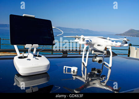 Drone aircraft and the control unit the car roof. Stock Photo