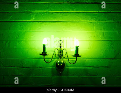 Green, toxic chandelier, lantern powered on hanging on the wall in landscape format Stock Photo