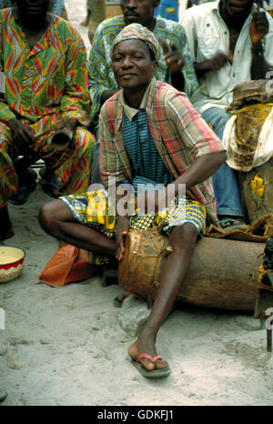 A drummer in a village near Cotonou during a Voodoo ceremony in Benin, West Africa. Stock Photo