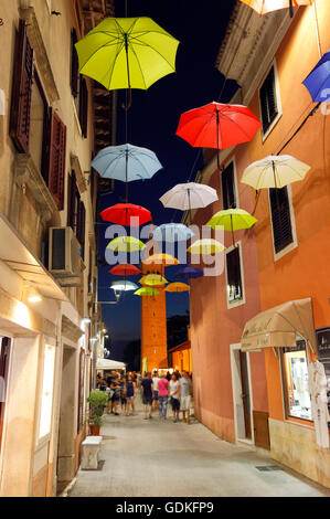 Open umbrellas hanging from strings in the street of Novigrad Stock Photo