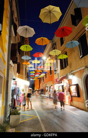 Open umbrellas hanging from strings in the street of Novigrad Stock Photo