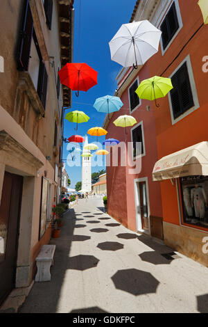 Open umbrellas hanging from strings in the street of Novigrad Stock Photo