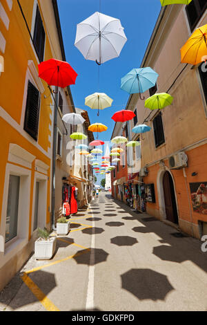 Open umbrellas hanging from strings in the street of Novigrad Stock Photo