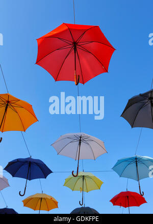 Open umbrellas hanging from strings in the street of Novigrad Stock Photo