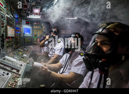 File photo dated 20/01/16 of members of the Royal Navy respond to a simulated fire in a Vanguard-class submarine control room simulator at a training facility in HM Naval Base Clyde, also known as Faslane, as Theresa May will tell MPs not to gamble with the safety of British families ahead of a Commons vote on whether to renew the Trident nuclear deterrent. Stock Photo