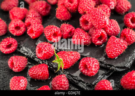 Fresh red raspberries on a slate background Stock Photo