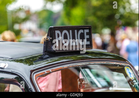 Police sign on the roof of an old black car car Stock Photo