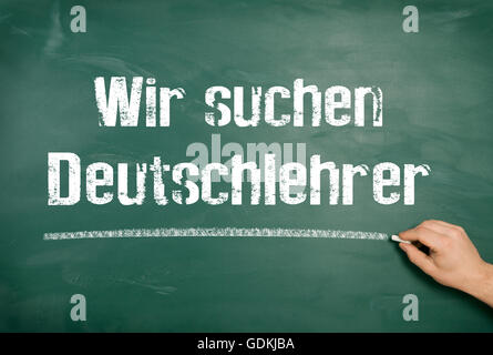 On a blackboard the text is written we are seeking German teacher by hand Stock Photo