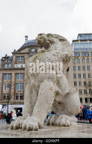 A lion statue near the National Monument in Dam Square in Amsterdam, Holland, Netherlands. Stock Photo