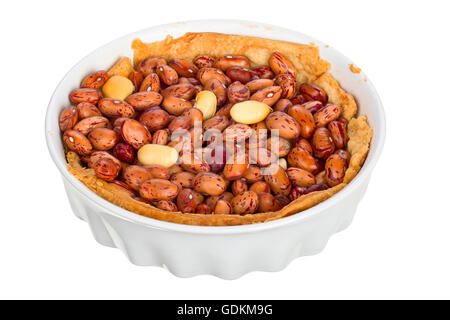 Handmade quiche in a small baking dish isolated on white background. Stock Photo
