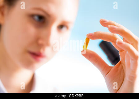 Doctor woman hold medicine capsule, pill in hand Stock Photo