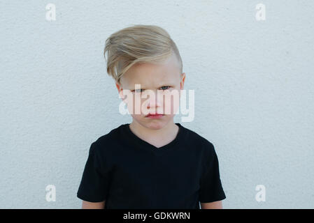 young emotional boy on bright background Stock Photo