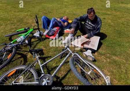 Promenade beach, rest on  Lawn park in front of Mar Bella beach, Barcelona, Spain Stock Photo