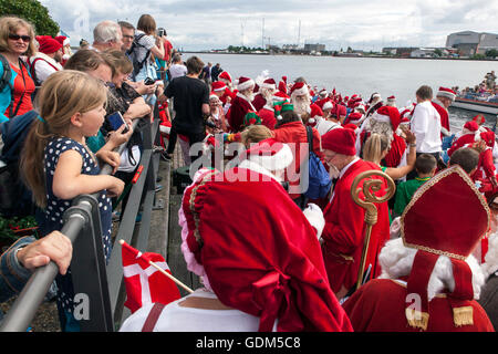 Copenhagen, Denmark – July 18, 2016: Santa’s participating in in the World Santa Claus Congress 2016 visits the harbor promenade, Langelinie, in Copenhagen, and boards a boat for their further trip to the inner city of the Danish Capital, where they will walk in parade through the main shopping area, Stroeget to the City Hall. The congress has taken place since 1957. The venue and organizer is Bakken, the world’s oldest amusement park and located north of Copenhagen. Credit:  OJPHOTOS/Alamy Live News Stock Photo