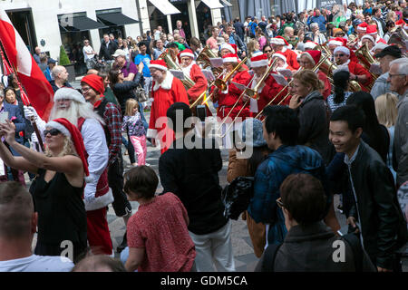 Copenhagen, Denmark – July 18, 2016: Participants in the in World Santa Claus Congress 2016 walks in parade through the main shopping street, Stroeget, in Copenhagen. They began their tour through the Danish Capital by visiting The Little Mermaid sculpture at the harbor promenade, Langelinie, and from there by boat to the inner city. The congress has taken place since 1957. The venue and organizer is Bakken, the world’s oldest amusement park and located north of Copenhagen. Credit:  OJPHOTOS/Alamy Live News Stock Photo