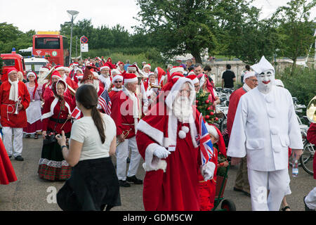 Copenhagen, Denmark – July 18, 2016:  Santa Claus’ participating in the World Santa Claus Congress 2016 visits the harbor promenade, Langelinie, where the sculpture, The Little Mermaid is placed, and hands out hands out candy to kids. They also had some serious talks to the kids about the upcoming Christmas and whish list.  The congress has taken place since 1957. The venue and organizer is Bakken, the world’s oldest amusement park and located north of Copenhagen. Credit:  OJPHOTOS/Alamy Live News Stock Photo